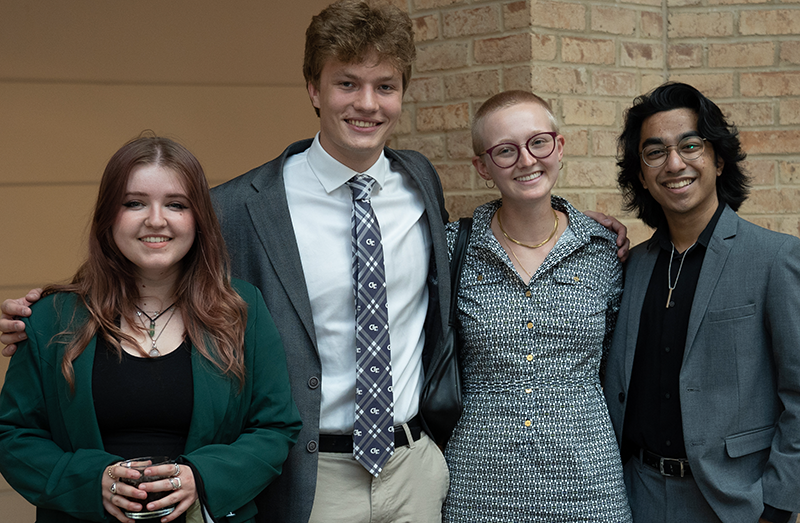 Four LEAD participants. Two young women and two young men smiling at the camera.